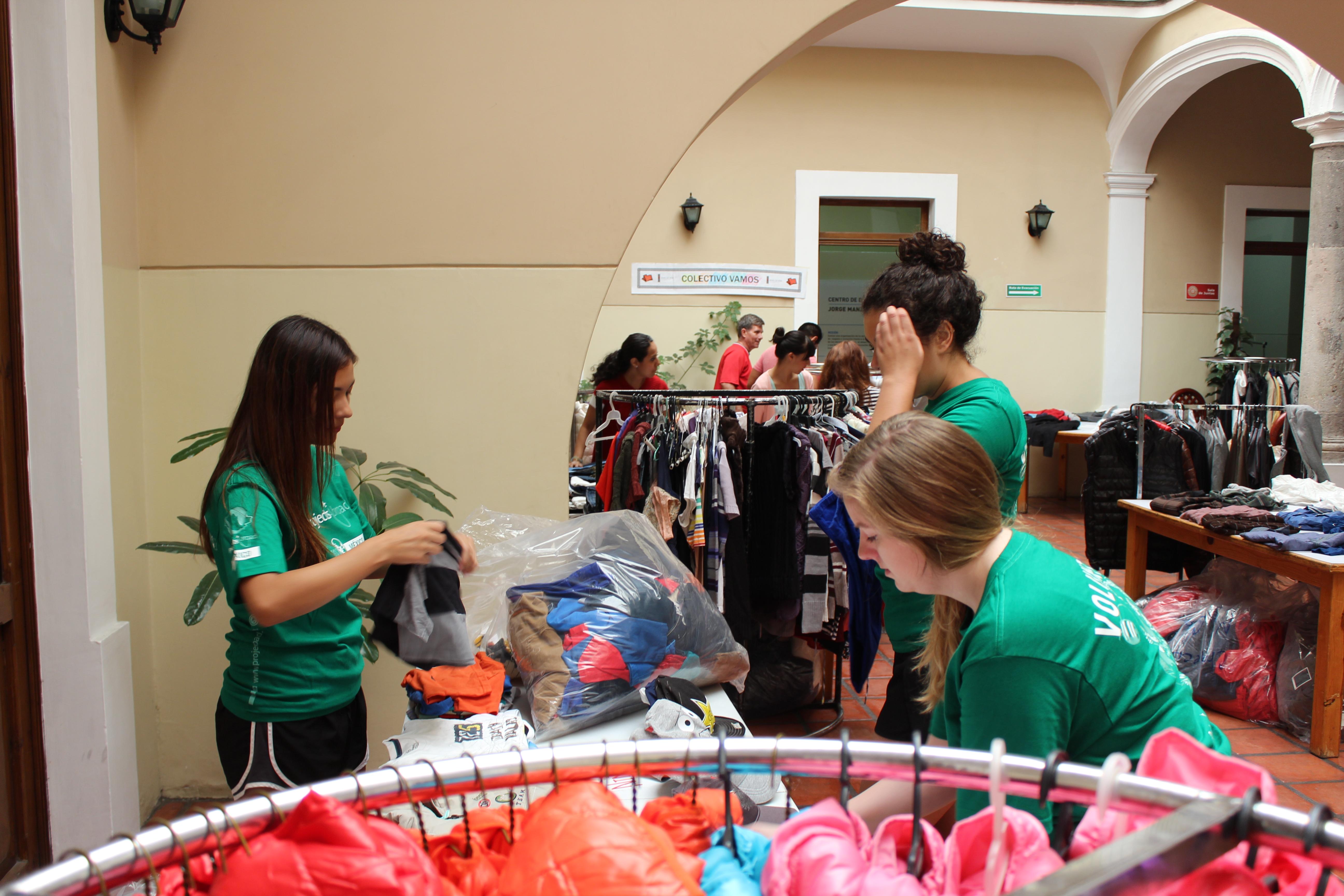 Female Projects Abroad Business Interns are packing bags full of clothes at a clothes shop during their Business Internship in Mexico. Female Interns are sorting through bags of clothes at a clothes companies store during their work placement in Mexico.